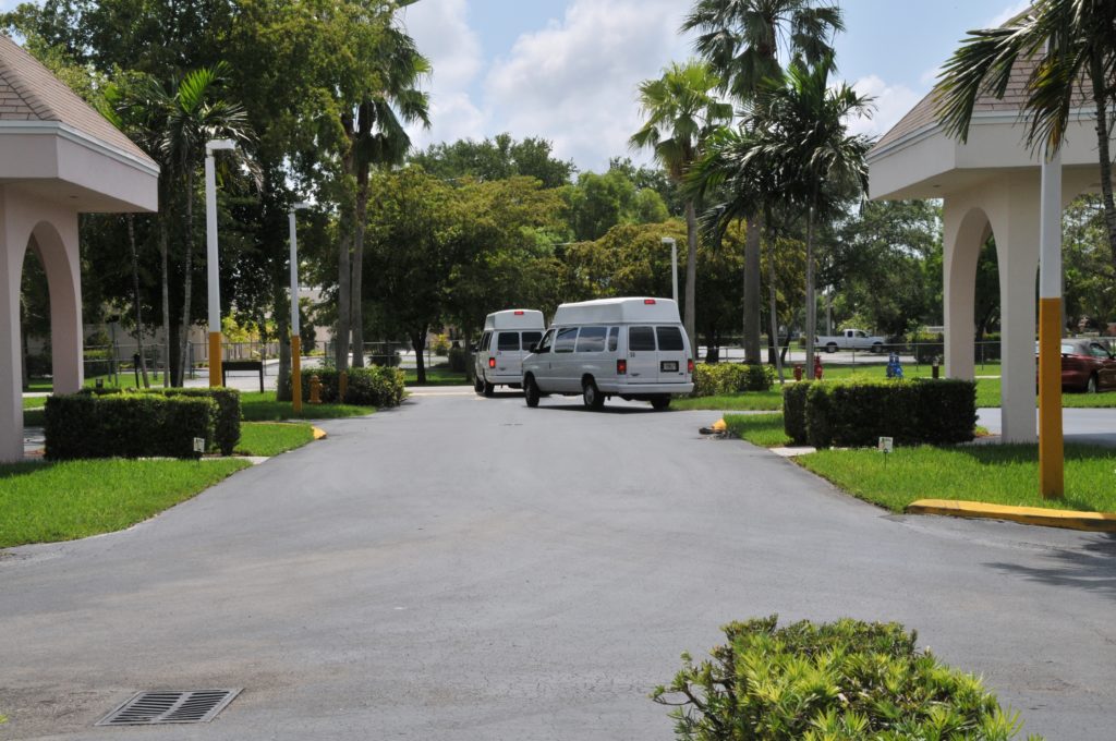 Vans Driving Away in Parking Lot